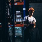 Young man working at a warehouse with boxes